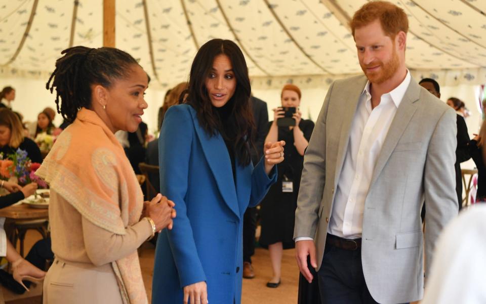 The Duchess of Sussex with her mother, Doria Ragland and Prince Harry, at Kensington Palace last year - AFP