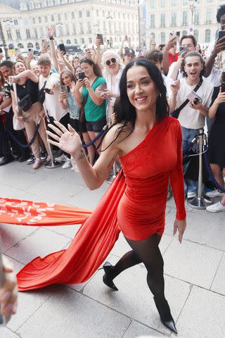 <p>Neil Mockford/GC Images</p> Katy Perry greets fans in skintight dress outside The Ritz Paris