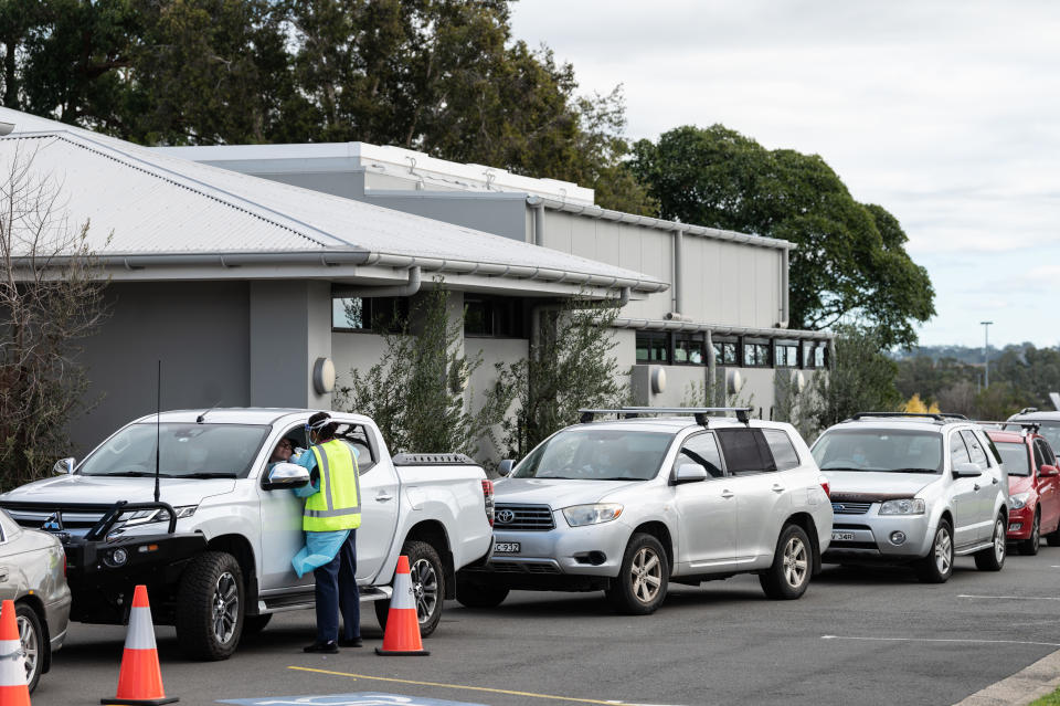 People line up in their cars at Sydney's Crossroads Hotel to get tested in Casula.