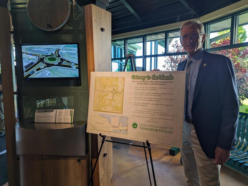 Larry Fletcher, president of Shores and Islands Ohio, speaks Monday in front of a display showing the double roundabout Gateway to the Islands construction project.