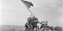 In this February 23, 1945 file photo, US Marines of the 28th Regiment, 5th Division, raise the American flag atop Mt. Suribachi, Iwo Jima, Japan. AP Photo/Joe Rosenthal