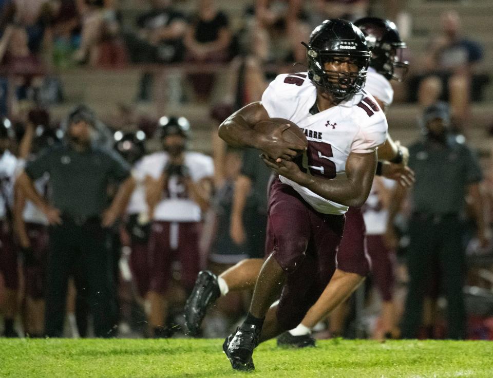 Navarre High running back Joshua Wilson(No. 15) takes the handoff and looks for a hole in the Pine Forest defensive line on Friday, September 1, 2023.