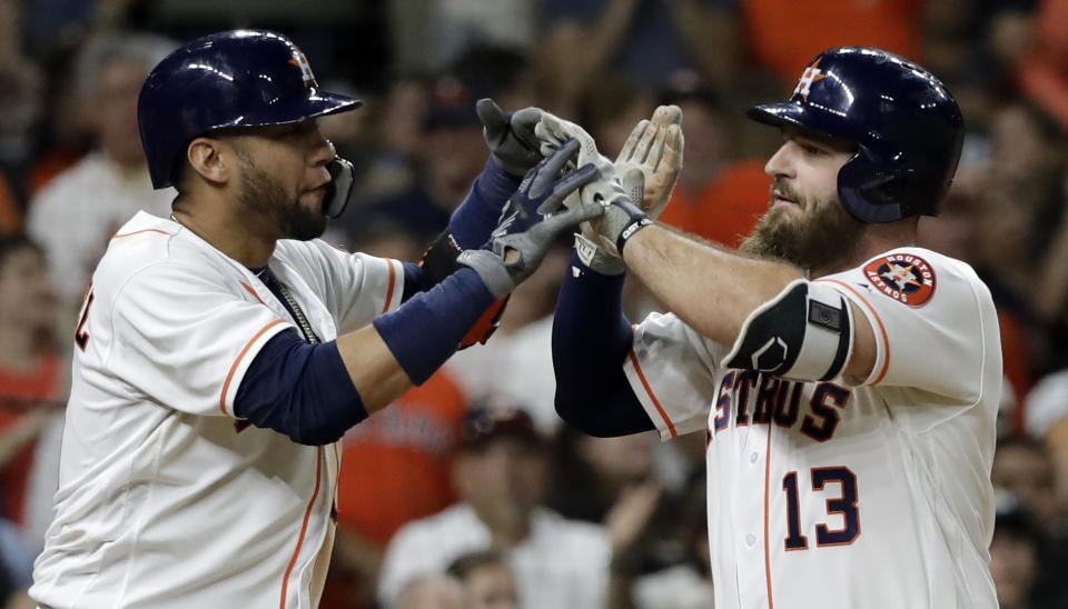Houston Astros' Tyler White (13) celebrates with Yuli Gurriel after both scored on White's home run against the Colorado Rockies during the fifth inning of a baseball game Wednesday, Aug. 15, 2018, in Houston. (AP Photo/David J. Phillip)