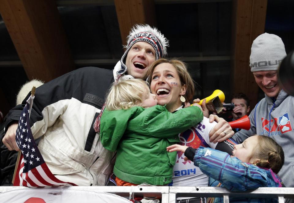 ADDS ID OF MAN AT LEFT - Noelle Pikus-Pace of the United States celebrates with her brother Jared Pikus, left, husband, Janson Pace, far right, and children, Traycen, left, and Lacee, right, after she won the silver medal during the women's skeleton competition at the 2014 Winter Olympics, Friday, Feb. 14, 2014, in Krasnaya Polyana, Russia. (AP Photo/Michael Sohn)