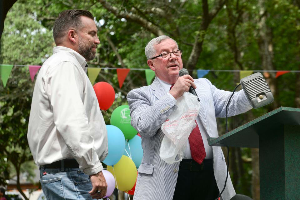 Tom Rice, right, presents Shalimar Mayor Mark Franks with a speaker from the old Florida Drive-In theater during Saturday's celebration of the town of Shalimar's 75th anniversary.