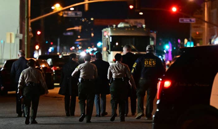 Investigators from the Los Angeles County Sheriff's Department Homicide Bureau walk away after briefing the media in Monterey Park, California, on Jan. 22, 2023.