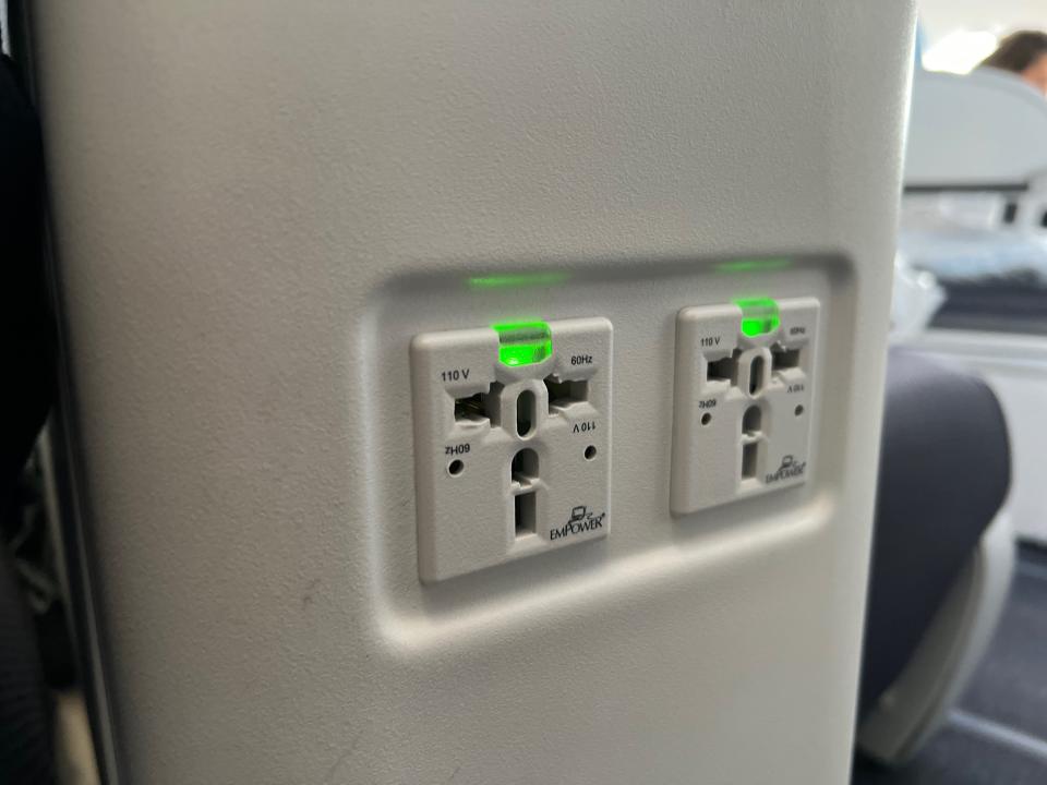 Flying on La Compagnie all-business class airline from Paris to New York — two power outlets located on the front of the middle divider.