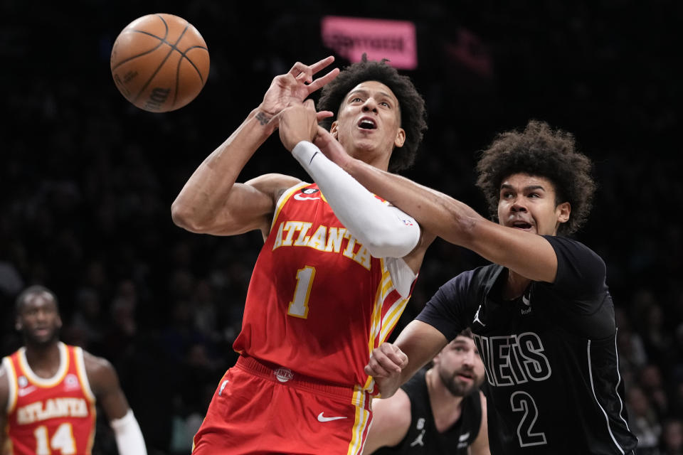 Brooklyn Nets forward Cameron Johnson (2) fouls Atlanta Hawks forward Jalen Johnson (1) during the first half of an NBA basketball game Friday, March 31, 2023, in New York. (AP Photo/Mary Altaffer)