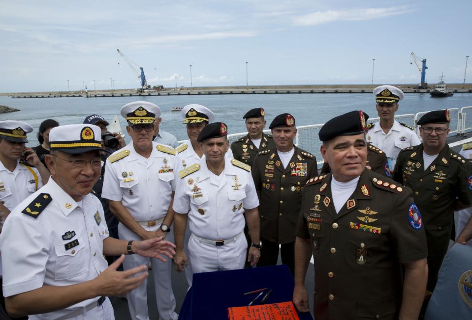 Chinese ship commander Guan Bai Lin , left corner, speaks with Venezuela's Defense Minister Vladimir Padrino, right corner as they tour the Chinese navy hospital ship "The Peace Ark" at the port in la Guaira, Venezuela, Saturday, Sept. 22, 2018. The stop by the People's Liberation Army Navy's ship is the latest in an 11-nation "Mission Harmony" tour and will provide free medical treatment for Venezuelans. (AP Photo/Ariana Cubillos)