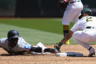 Oakland Athletics shortstop Darell Hernaiz, right, tags out Miami Marlins' Nick Gordon, left, at second base on a steal-attempt during the third inning of a baseball game Sunday, May 5, 2024, in Oakland, Calif. (AP Photo/Godofredo A. Vásquez)