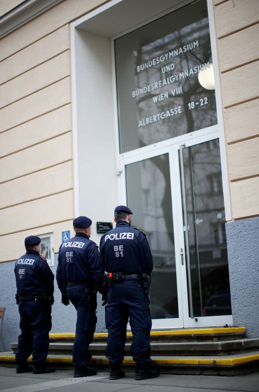 Policemen guard the entrance of a school, after authorities put the school under isolation after a teacher returned from a travel in Northern Italy, in Vienna