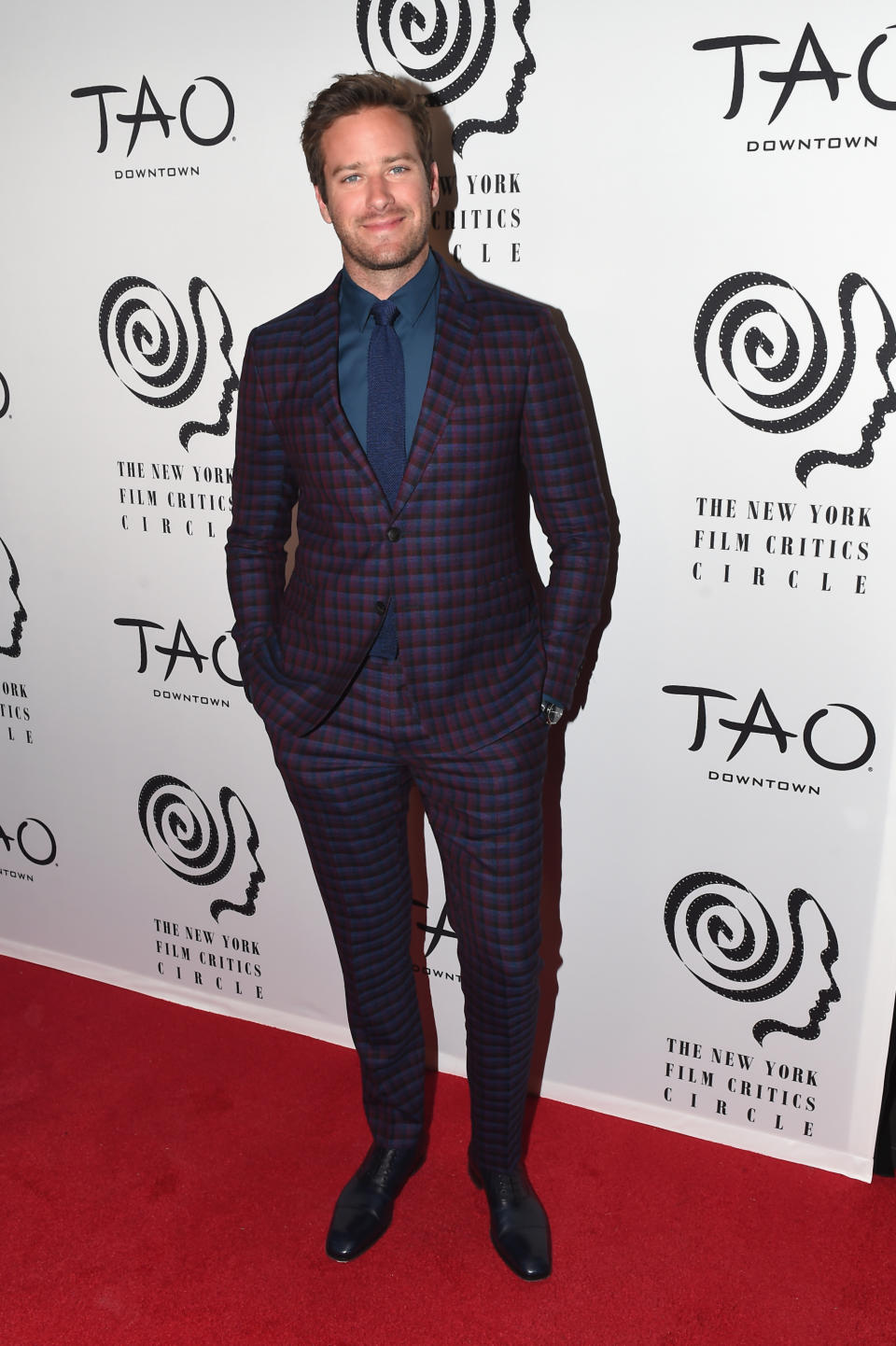 <p>The actor wore a checked, plum Etro suit with a blue shirt and tie. <em>[Photo: Getty]</em> </p>