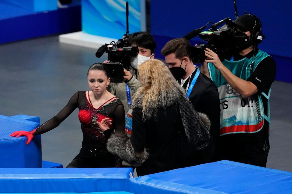 Kamila Valieva, of the Russian Olympic Committee, talks with her coach Eteri Tutberidze after the women's free skate program during the figure skating competition at the 2022 Winter Olympics.