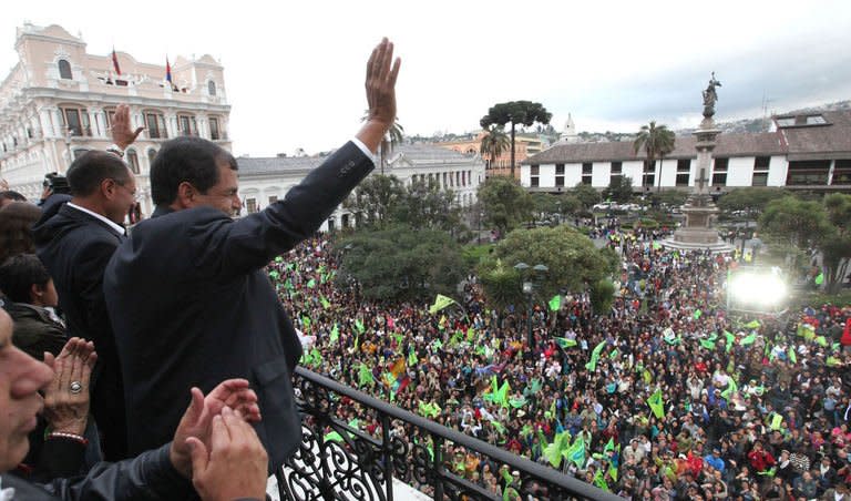 Ecuadorean President Rafael Correa waves to supporters as he celebrates his re-election, at Carondelet presidential palace in Quito on February 17, 2013. If the activist-leftist can secure an absolute majority in Ecuador's National Assembly he would have free rein to regulate the media, redistribute land and make other controversial changes