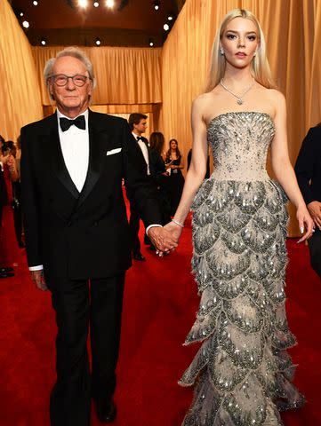 <p>Valerie Macon/AFP/Getty</p> Anya Taylor-Joy arrives with her father Dennis Taylor