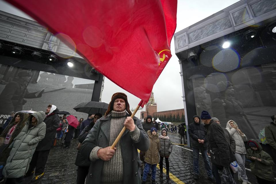 A participant dressed in Red Army World War II uniform in the role of a military traffic controller takes part in a theatrical performance at an open air interactive museum to commemorate the 82nd anniversary of the World War II-era parade, at Red Square, in Moscow, Russia, on Monday, Nov. 6, 2023. The theatrical performance marks the 82nd anniversary of a World War II historic parade in Red Square and honored the participants in the Nov. 7, 1941 parade who headed directly to the front lines to defend Moscow from the Nazi forces. (AP Photo/Alexander Zemlianichenko)