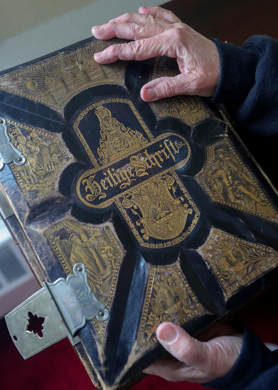 Norton historian Lisa Merrick shows an 1883 German Bible on display at Grace United Church of Christ of Loyal Oak.