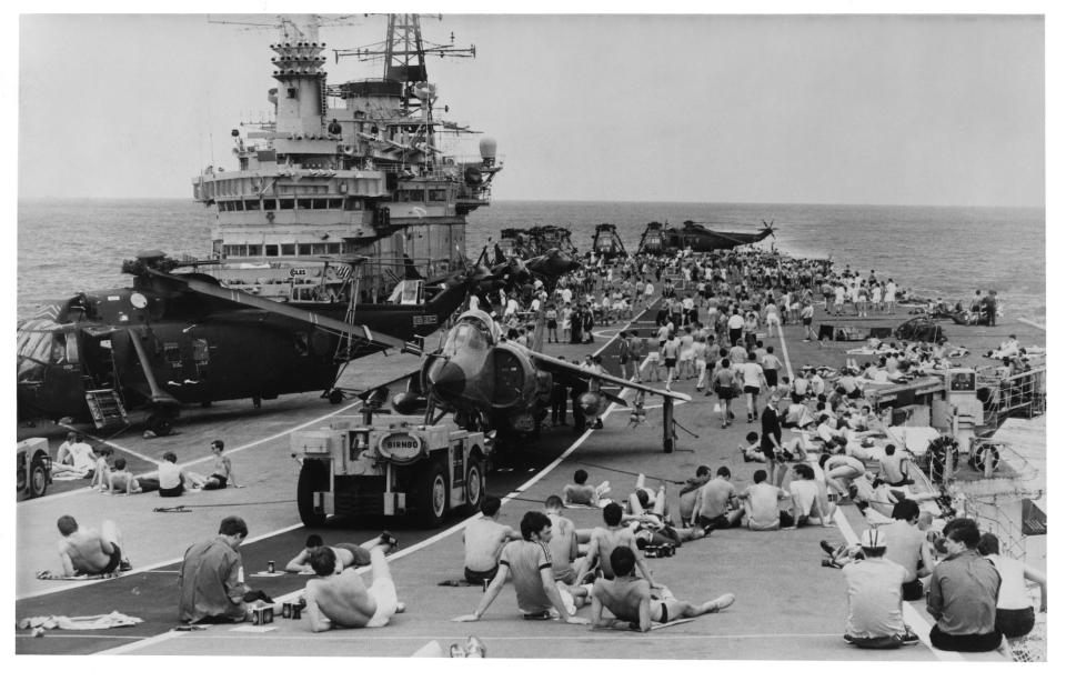 Royal Navy crewmen aboard aircraft carrier HMS Hermes