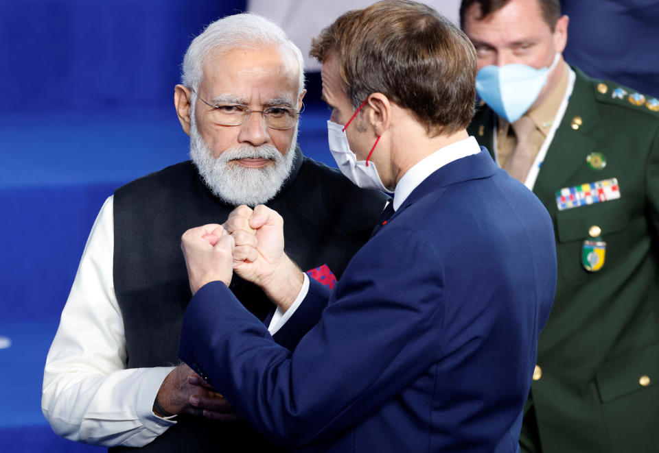 French President Emmanuel Macron, right, speaks with India's Prime Minister Narendra Modi during a group photo at the La Nuvola conference center for the G20 summit in Rome, Saturday, Oct. 30, 2021. The two-day Group of 20 summit is the first in-person gathering of leaders of the world's biggest economies since the COVID-19 pandemic started. (Ludovic Marin, Pool Photo via AP)