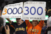 Fans hold up signs for Houston Astros starting pitcher Justin Verlander after he completed 3,000 career strikeouts and 300 season strikeouts during a baseball game against the Los Angeles Angels Saturday, Sept. 28, 2019, in Anaheim, Calif. (AP Photo/Mark J. Terrill)