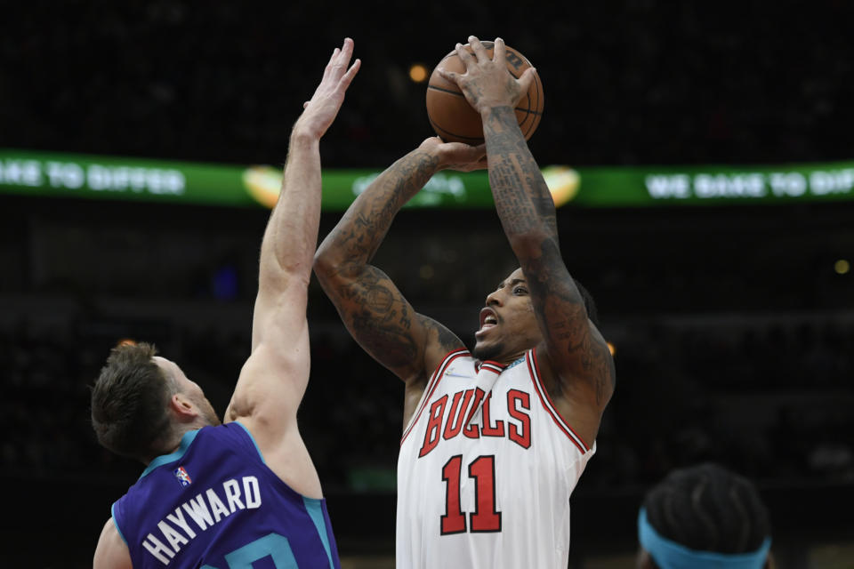 Chicago Bulls forward DeMar DeRozan (11) goes up for a shot against Charlotte Hornets forward Gordon Hayward (20) during the first half of a NBA basketball game Monday, Nov. 29, 2021 in Chicago. (AP Photo/Paul Beaty)