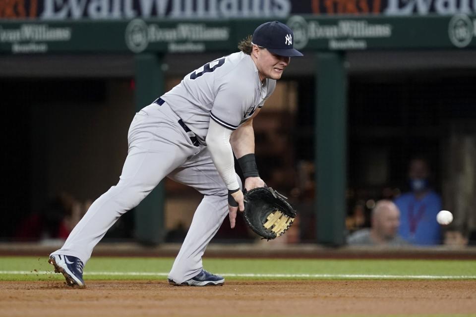 New York Yankees first baseman Luke Voit reaches out to field a grounder by Texas Rangers' Nate Lowe, who was out during the first inning of a baseball game in Arlington, Texas, Wednesday, May 19, 2021. (AP Photo/Tony Gutierrez)