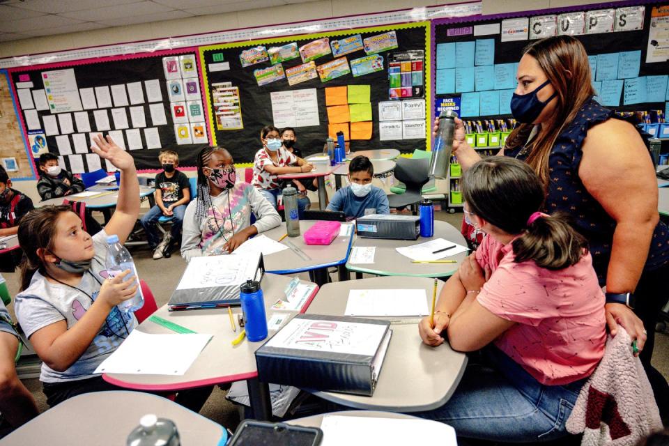 Teachers are in such short supply across the country that it can be hard to find substitutes, like Veronica Roman, right, seen subbing in a California classroom. <a href="https://www.gettyimages.com/detail/news-photo/veronica-roman-a-long-term-substitute-teacher-works-with-news-photo/1235434192" rel="nofollow noopener" target="_blank" data-ylk="slk:Watchara Phomicinda/MediaNews Group/The Press-Enterprise via Getty Images;elm:context_link;itc:0;sec:content-canvas" class="link ">Watchara Phomicinda/MediaNews Group/The Press-Enterprise via Getty Images</a>