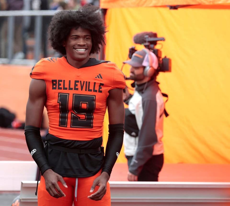 Belleville quarterback Bryce Underwood is all smiles as he warms up on the sidelines before first-half action in the MHSAA Division 1 playoff game between Saline and Belleville at Belleville High School on Saturday, Nov. 4, 2023.