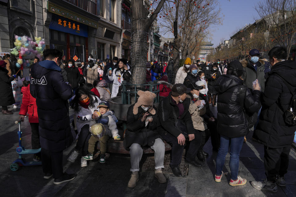 FILE - Visitors tour a pedestrian shopping street at Qianmen, a popular tourist spot on the first day of the Lunar New Year holiday in Beijing on Jan. 22, 2023. (AP Photo/Andy Wong, File)