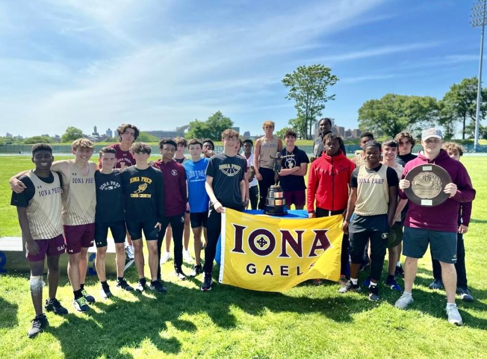 Iona Prep athletes stand with trophies at Ichan Stadium in New York City May 27, 2023 after the Gaels won the state Catholic outdoor track and field boys team title for the third time in the school's history and in the 95th year of the competition.