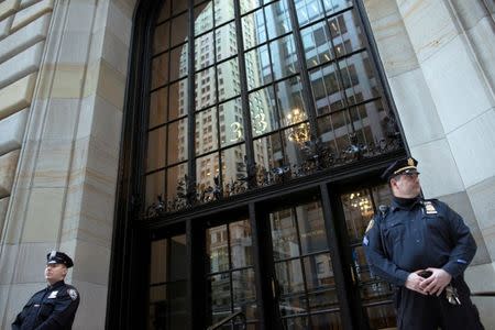 FILE PHOTO - Federal Reserve and New York City Police officers stand guard in front of the New York Federal Reserve Building in New York, October 17, 2012. REUTERS/Keith Bedford/File Photo