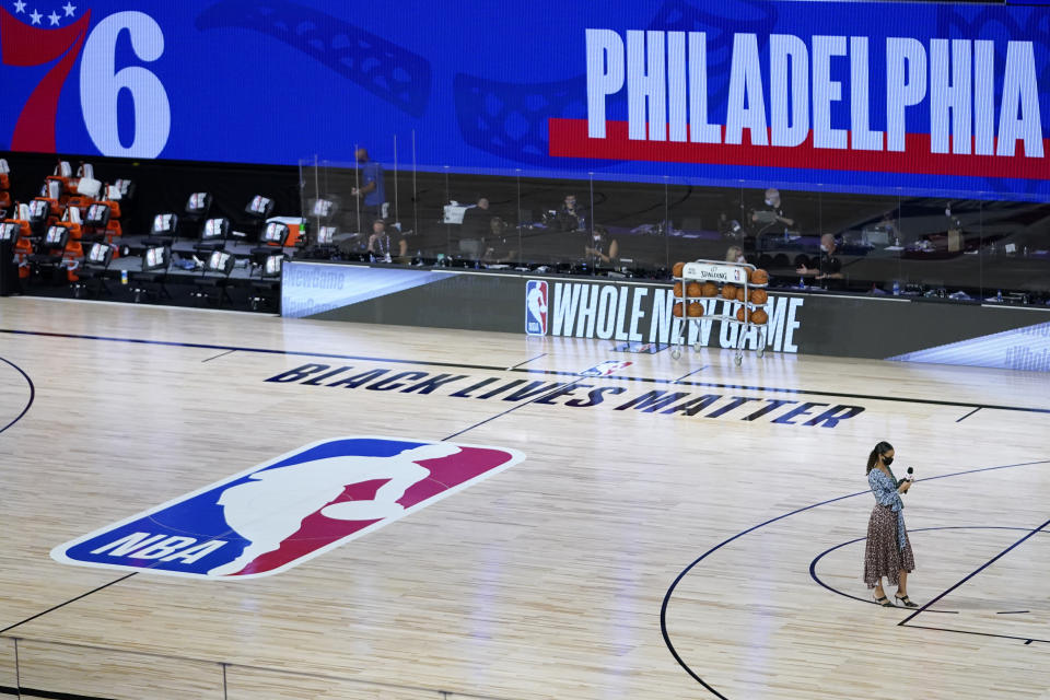 Malika Andrews in the bottom right corner on the NBA court that says "Black Lives Matter." 