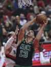 Boston Celtics center Enes Freedom, right, looks to shoot against Portland Trail Blazers center Cody Zeller, left, during the first half of an NBA basketball game in Portland, Ore., Saturday, Dec. 4, 2021. (AP Photo/Steve Dipaola)