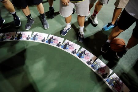 Protester stand near altered pictures with NBA star LeBron James during a gathering in support of NBA's Houston Rockets' team general manager Daryl Morey, who sent a tweet backing the pro-democracy movement, in Hong Kong