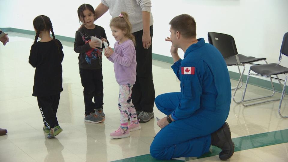 Jermey Hansen greets kids, and tells them about his space mission.