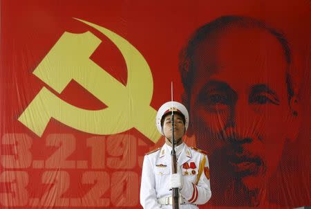 A soldier holds a rifle in front of a large image of Vietnam's late revolutionary leader Ho Chi Minh, outside a ceremony to celebrate his birthday in Hanoi, in this May 18, 2010 file photo. REUTERS/Kham/Files