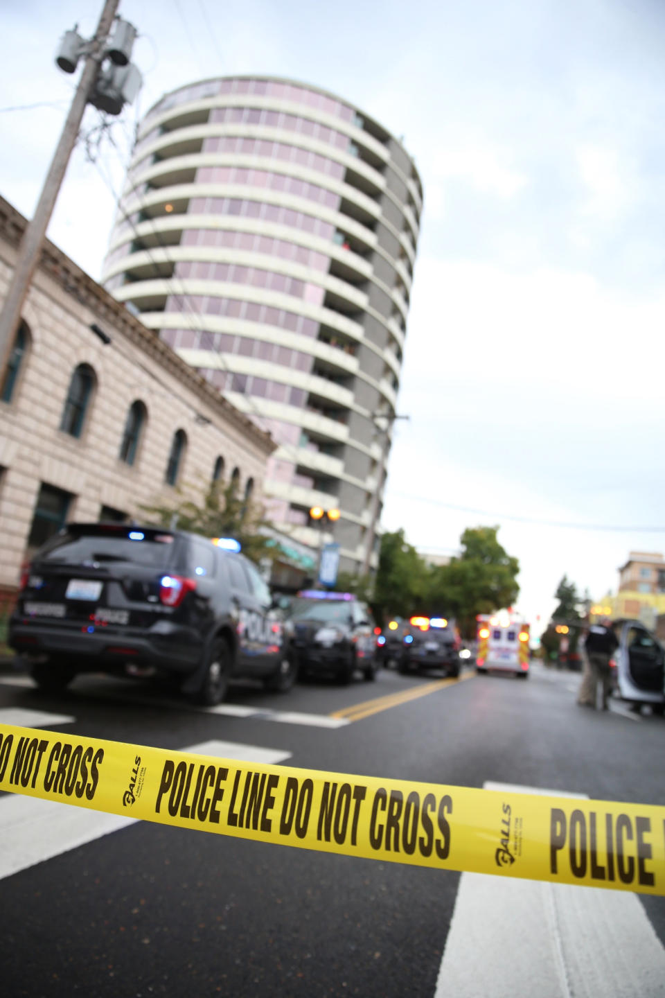 Police respond to a report of gunfire at Smith Tower Apartments in downtown Vancouver, Wash., on Thursday, Oct. 3, 2019. Police say a man suspected of shooting several people in the lobby of the apartment building for the elderly has been taken into custody. (Mark Graves/The Oregonian via AP)