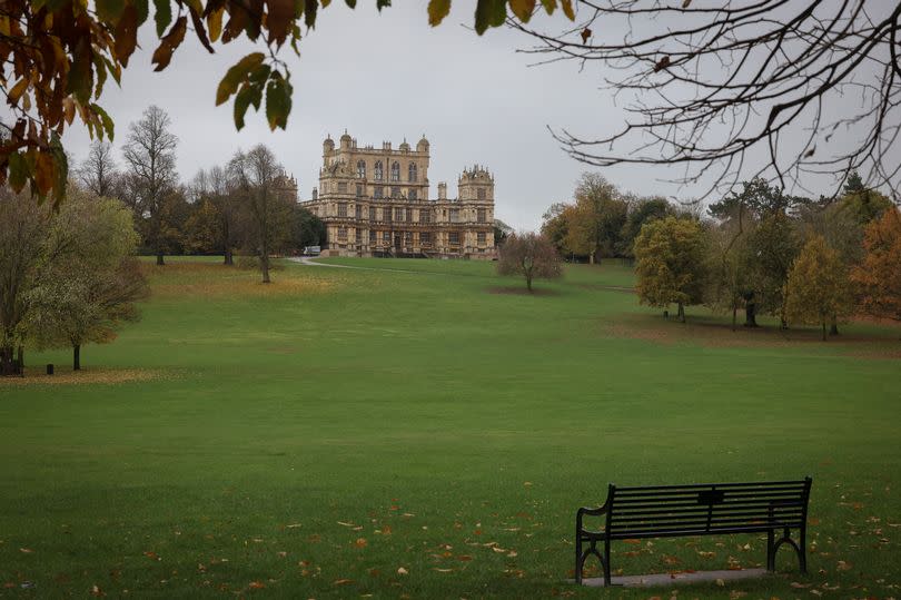 A general view of Wollaton Hall and Deer Park in Wollaton, Nottingham with a bench in the foreground and the hall in the distance.