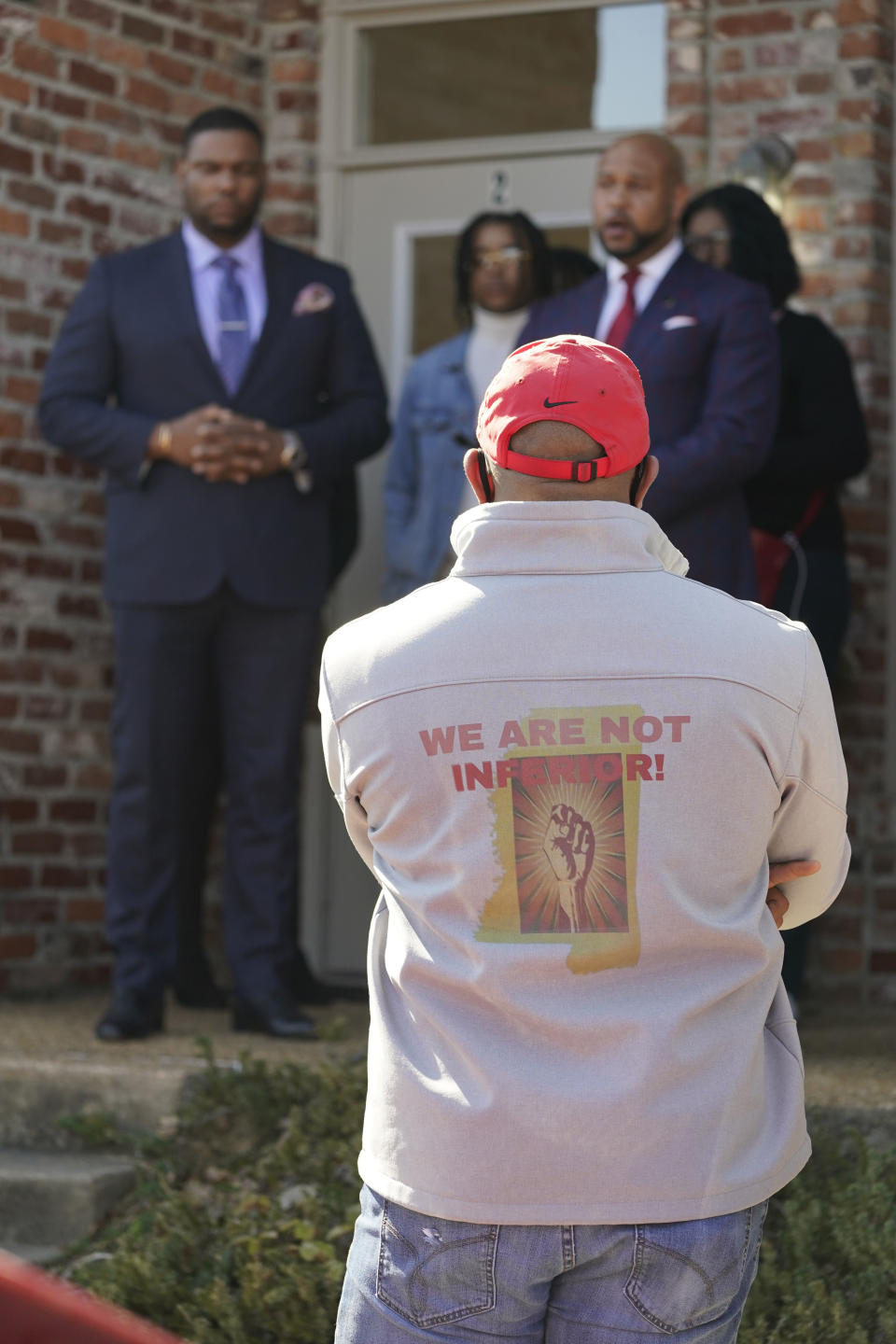 A observer listens to a news conference by FedEx driver Demonterrio Gibson and his legal team in Ridgeland, Miss., Thursday, Feb. 10, 2022. Gibson and his attorneys say the delivery driver was shot at by a white father and son on Jan. 24, 2022 in Brookhaven and that both suspects have been "undercharged" and should face charges of attempted murder and hate crimes. (AP Photo/Rogelio V. Solis)