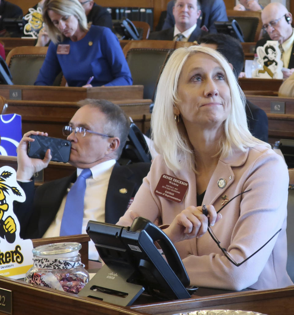 Kansas state Rep. Renee Erickson, right, R-Wichita, and Rep. Shannon Francis, R-Liberal, watch an electronic tally board as the House approves a resolution condemning a new New York law protecting abortion rights, Wednesday, March 13, 2019, at the Statehouse in Topeka, Kansas. Both supported the resolution.(AP Photo/John Hanna)