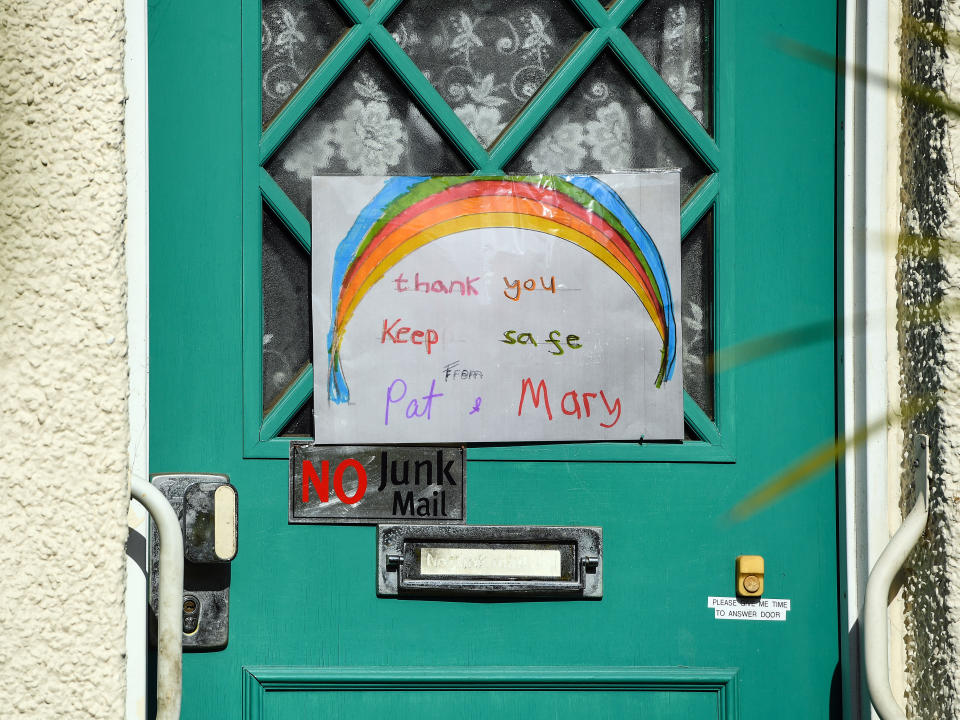Hand painted pictures of colourful rainbows are displayed on the door of a home in South London as the UK continues in lockdown to help curb the spread of the coronavirus.