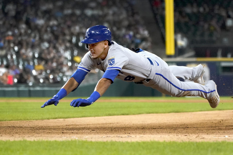 Kansas City Royals' Nicky Lopez dives back to first after his single off Chicago White Sox starting pitcher Lucas Giolito in the fourth inning of a baseball game Tuesday, Aug. 2, 2022, in Chicago. (AP Photo/Charles Rex Arbogast)