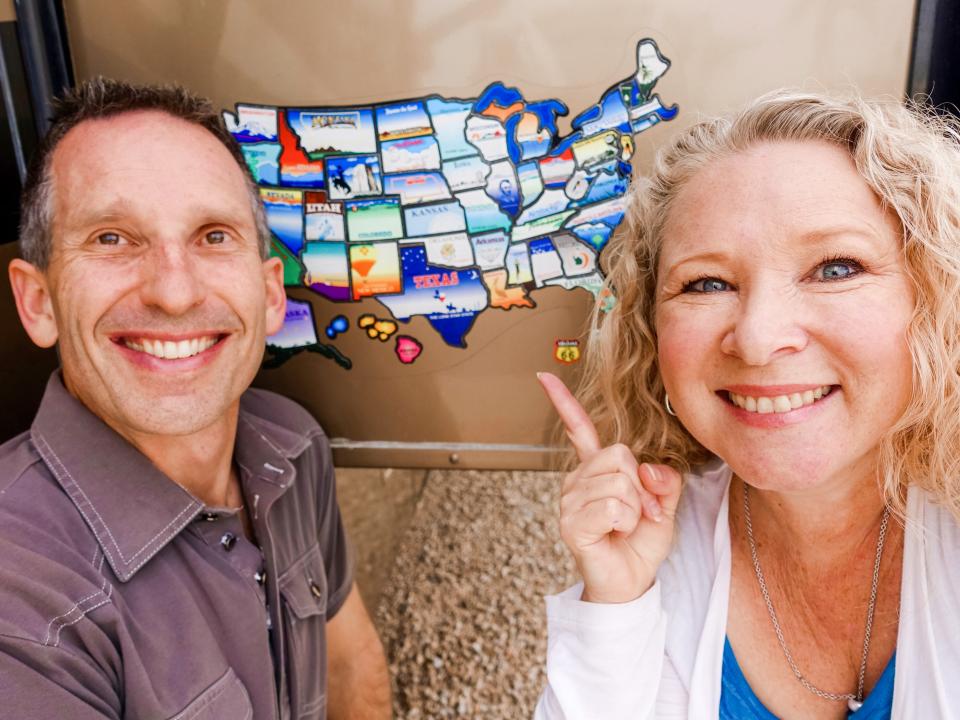 Marc and Julie pose for a close-up with a map of the US