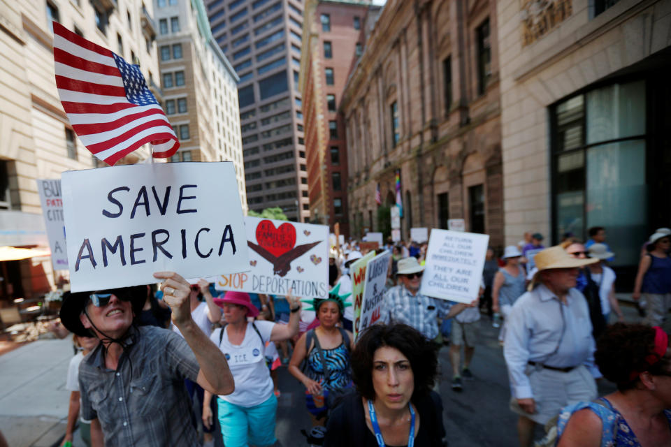 <p>Demonstrators carrying signs, including one reading “Save America”, march during the “Families Belong Together” rally in Boston, Mass., June 30, 2018 (Photo: Brian Snyder/Reuters) </p>