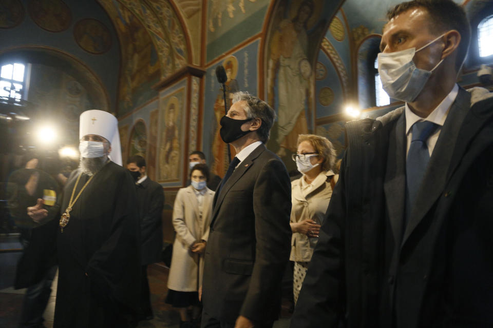 U.S. Secretary of State Antony Blinken, centre, accompanied by the Head of the Independent Ukrainian Church Metropolitan Epiphanius, left, visit the Mikhailovsky Zlatoverkhy Cathedral (St. Michael's Golden-Domed Cathedral) in Kyiv, Ukraine, Thursday, May 6, 2021. Blinken is in Kyiv on Thursday, meeting top Ukrainian officials during a one-day visit that is highly anticipated in the country as it faces heightened tensions with Russia. (AP Photo/Efrem Lukatsky, Pool)