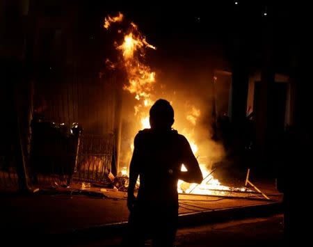 Protestors set fire to the Congress building during a demonstration against a possible change in law to allow for presidential re-election in Asuncion March 31, 2017. REUTERS/Jorge Adorno