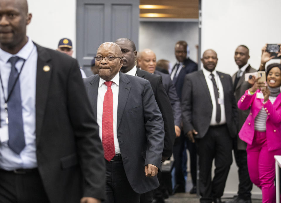 Former South Africa President Jacob Zuma , second left, arrives for a commission probing allegations of corruption during his tenure as the country's leader as president from 2009 until 2018, in Johannesburg Monday July 15, 2019. Zuma was forced to resign by his ruling African National Congress party over widespread reports of corruption and was replaced by his then deputy Cyril Ramaphosa. (Pool Photo via AP)