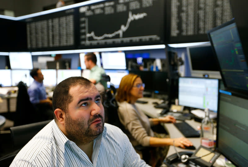 FILE PHOTO - Traders react at the stock exchange in Frankfurt, Germany, December 8, 2016. REUTERS/Ralph Orlowski