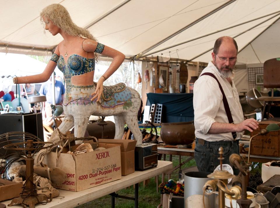 A man peruses a tent at the Brimfield Antique Flea Markets in 2016.