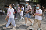 Tourists wear face masks as they visit the Summer Palace in Beijing Tuesday, Aug. 3, 2021. The current coronavirus outbreaks in China, while still in the hundreds of cases in total, have spread much more widely than previous ones, reaching multiple provinces and cities including the capital, Beijing. Many of the cases have been identified as the highly contagious delta variant that is driving a resurgence in many countries. (AP Photo/Ng Han Guan)